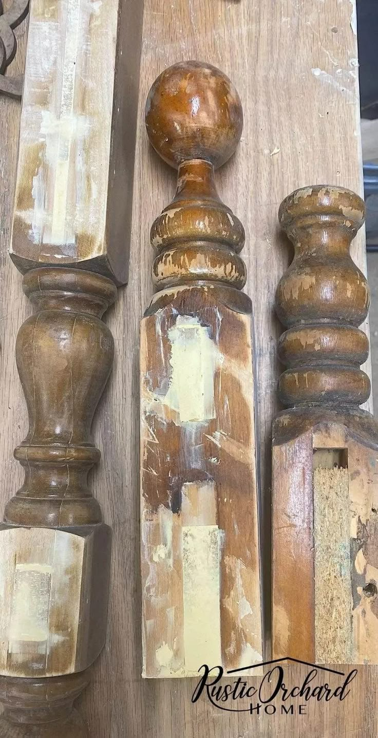 an assortment of wood and metal objects on a wooden table with paint peeling off the top