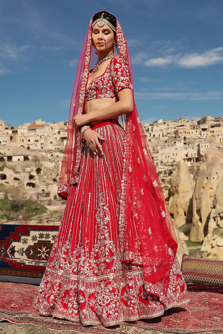 Red blouse with all-over heavy floral embroidery and plunging sweetheart neckline. Comes with lehenga and dupatta.
Component: 3
Embroidered
Neckline: Sweetheart
Sleeve Length: Full
Fabric: Dupion, Net
Color: Red
Tie-up at the back with tassels
Embroidered lehenga
Embellished dupatta
Closure: 
Blouse: Concealed zip closure at the side - Aza Fashions Embellished Choli For Festive Traditional Ceremonies, Embellished Lehenga For Traditional Ceremonies, Red Sharara With Floral Embroidery For Wedding, Red Floral Embroidered Dupatta For Wedding, Red Embellished Traditional Wear For Wedding, Red Floral Embroidered Choli For Wedding, Red Floral Embroidery Choli For Wedding, Red Wedding Choli With Floral Embroidery, Red Embellished Wedding Dupatta