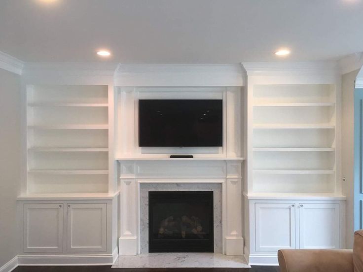 a living room filled with furniture and a flat screen tv mounted to the wall above a fireplace