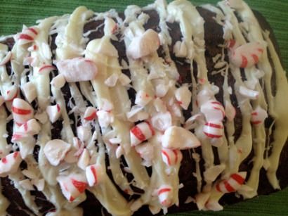 a large piece of cake covered in white frosting and candy canes