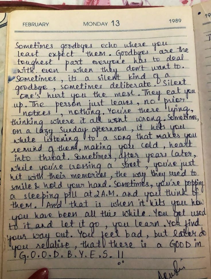 an old notebook with writing on it and someone holding a pen in their left hand