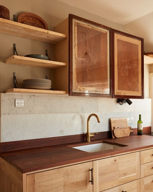 a kitchen with wooden cabinets and brown counter tops