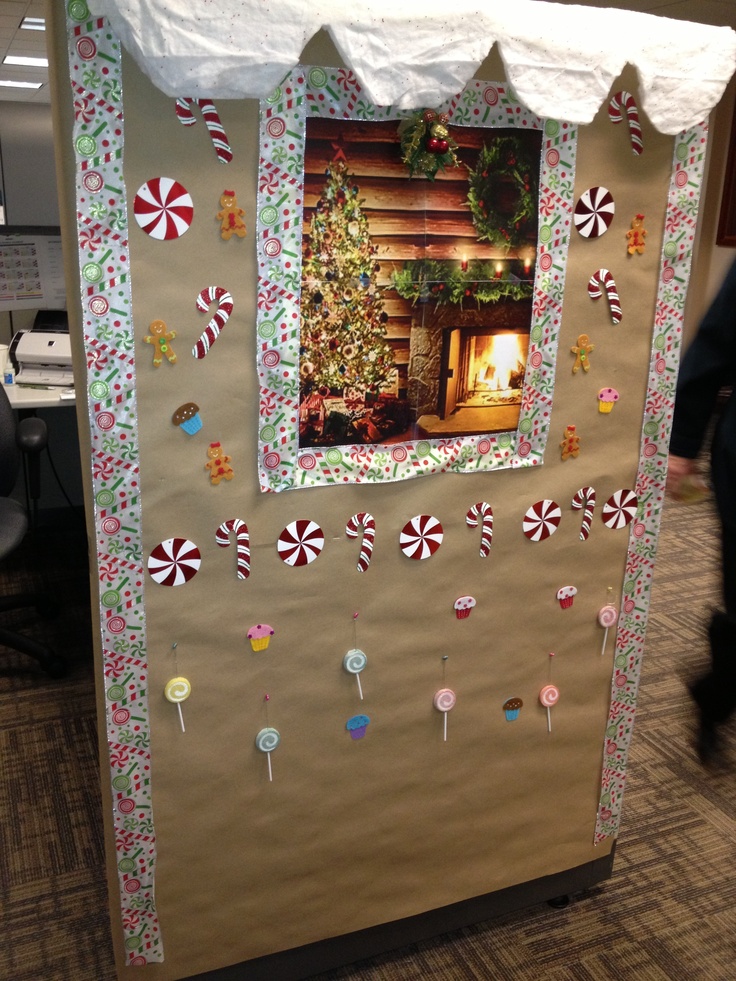 an office cubicle decorated for christmas with candy canes and candies on it