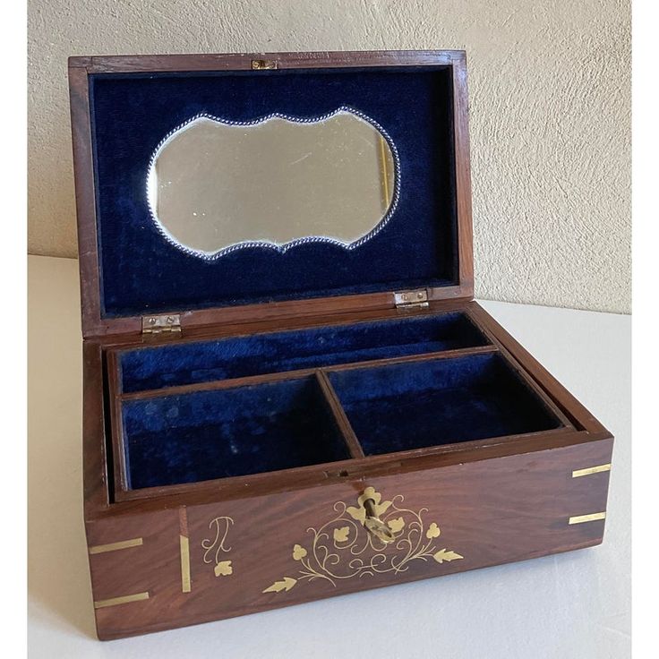 an open wooden box with blue velvet lining