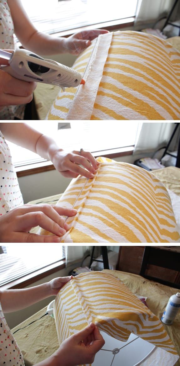 the woman is using scissors to cut fabric on the table top and place it in front of the window