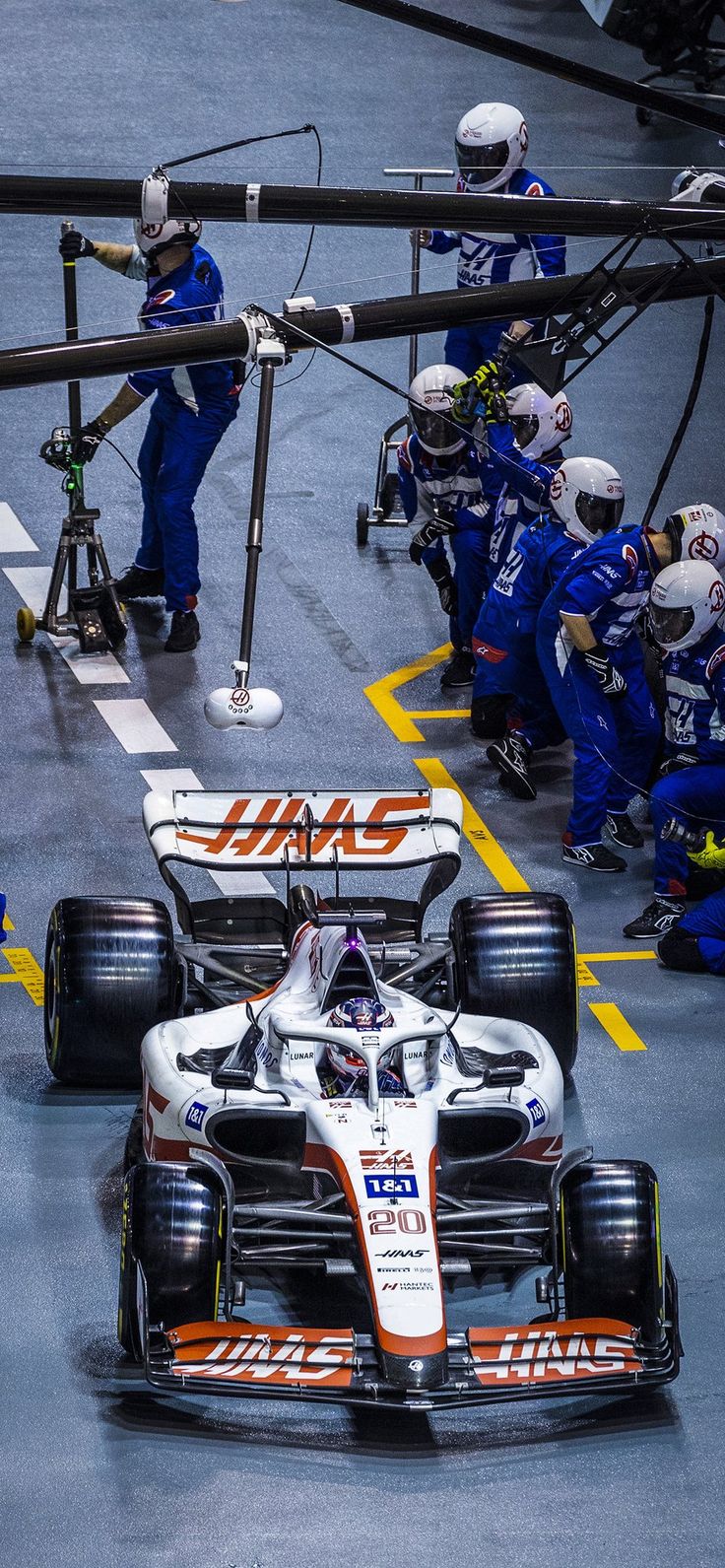 two racing cars driving down a race track