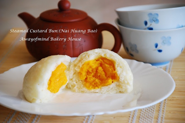 steamed custard buns with tangerine jelly in the middle on a plate