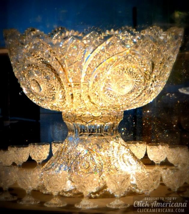 an ornate glass bowl sitting on top of a table