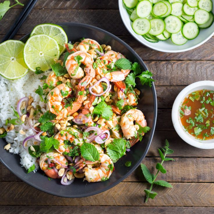 shrimp and vegetable stir fry served on a plate with chopsticks next to it