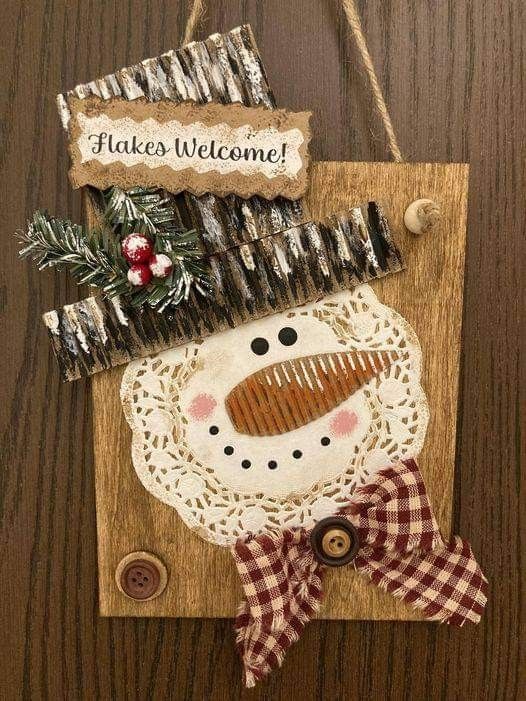 a wooden plaque with a snowman on it