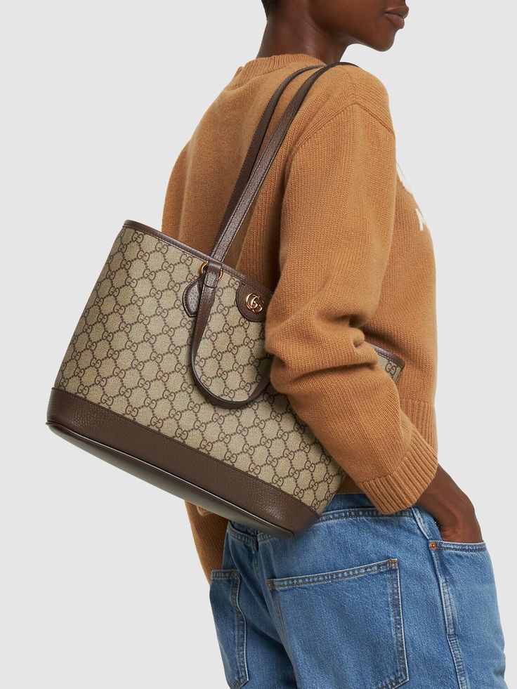 Height: 25cm Width: 31cm Depth: 13cm. Strap drop: 28.5cm. Top handle drop: 12cm. Double fixed straps. Double top handles. Logo details. All over pattern placement may vary. Gold-colored metal hardware. Leather trim. Cotton & linen lining Top Handle Shoulder Bag In Monogram Canvas, High-end Coated Canvas Shoulder Bag With Double Handle, Classic Monogram Canvas Top Handle Shoulder Bag, Classic Monogram Canvas Shoulder Bag With Top Handle, High-end Double Handle Coated Canvas Shoulder Bag, Modern Monogram Canvas Shoulder Bag With Double Handle, High-end Shoulder Bag With Double Leather Handles, Chic Monogram Canvas Shoulder Bag With Top Handle, Top Handle Monogram Canvas Shoulder Bag