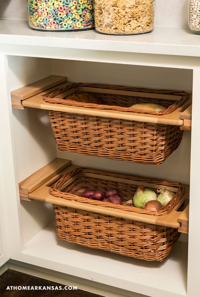 two wicker baskets are sitting on the shelves