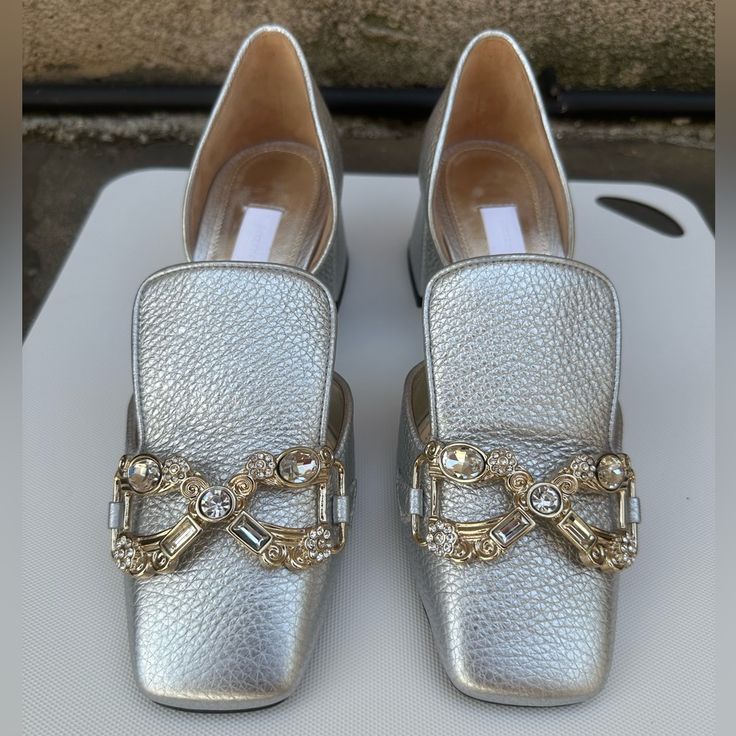 Gorgeous Pair Of Unworn D’orsay Loafers In Silver Pebbled Leather With Rhinestone Embellishments From Suzanne Rae. They Are The Best Mix Of Classy And Funkydress Down Your Party Dresses And Dress Up Your Jeans. They Are A Longer 37 So Do Not Size Up From 6.5. Original Dust Bag Included But No Box. Elegant Rhinestone Slip-on Loafers, Elegant Silver Slip-on Heels, Elegant Slip-on Flats With Almond Toe, Elegant Low Heel Flats With Metal Feet, Elegant Embellished Slip-on Flats, Evening Slip-on Loafers With Flat Heel, Embellished Flats With Flat Heel For Formal Occasions, Luxury Gold Loafers For Party, Elegant Formal Flats With Metal Feet