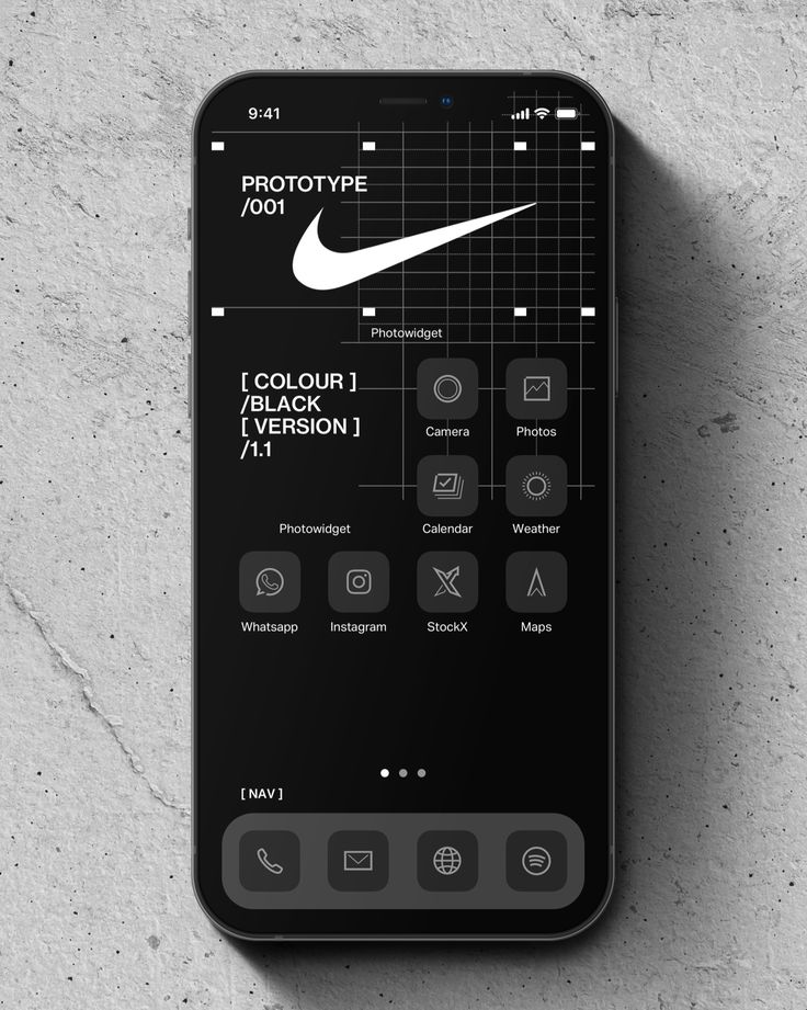 an iphone with the nike logo displayed on it's display screen, next to a concrete wall