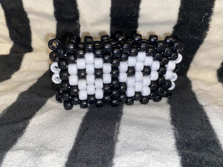 Handmade Kandi beaded bracelet with elastic. Will fit average size wrist of 6-8 inches, if a different size is needed please message so I can accommodate. Bracelet is approximately 2 inches tall. Looks great at any rave! Kandi Skeleton Hand, Goth Kandi, Goth Kandi Pattern, Emo Kandi, Spiked Kandi Cuff, Skull Kandi Cuff Pattern, Epic Kandi Cuff, Kandi Cuff, Beaded Cuff Bracelet