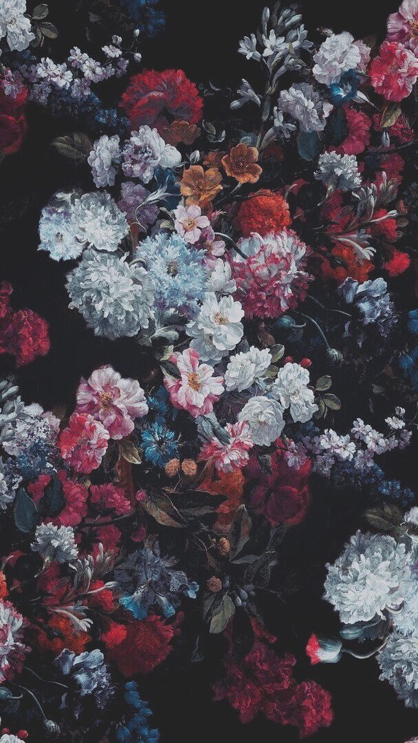 a bunch of flowers that are in the dark ground with one flower on it's side