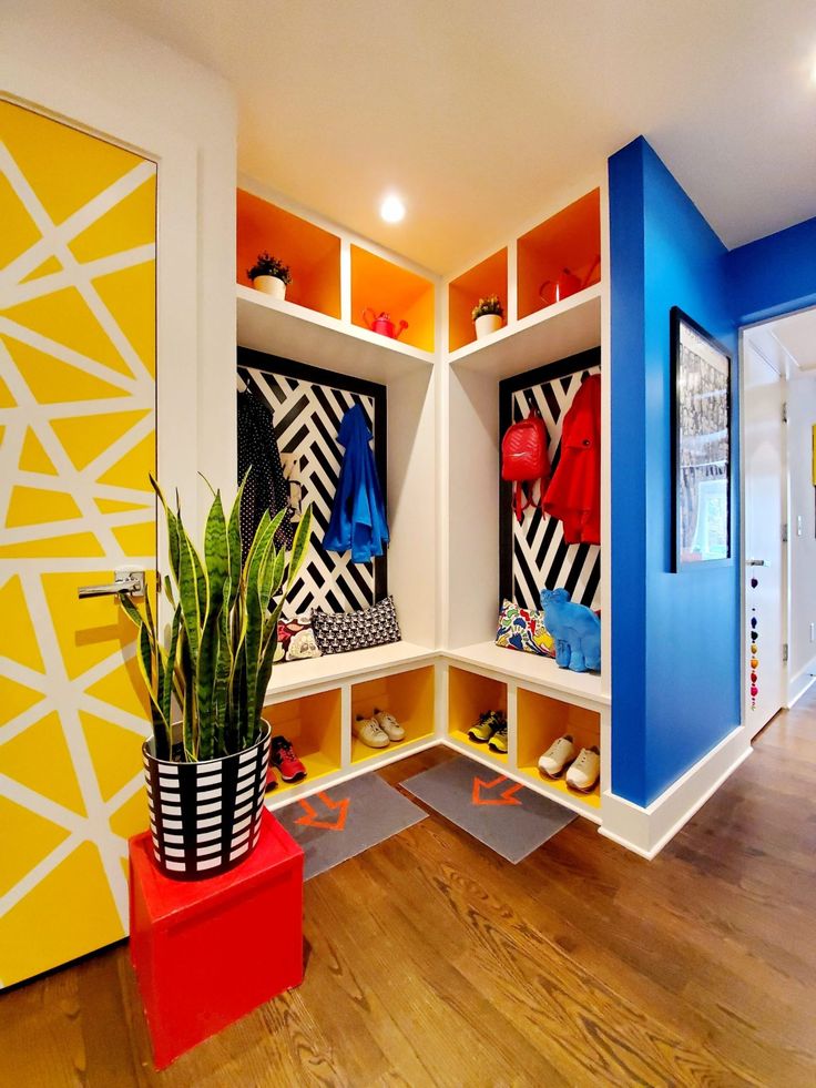 an entry way with colorful painted walls and wooden flooring, decorated in bright colors