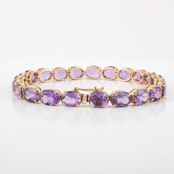 This is a classic-style tennis bracelet. A must-have statement piece for every woman. It's a classic luxury to have.-Material - 14K Solid Yellow Gold-Gemstone - Genuine Amethyst -Gross weight - 16.75 grams-Gemstone Weight - 28.190 CtThe bracelet length can be adjusted to your wrist size, on request.Amethyst Benefits :-         enhancing the immune system.    improving endocrine function.    improving the skin's appearance.    promoting digestive health.    reducing headaches.    regulating hormo Amethyst Benefits, Regulating Hormones, Vintage Charm Bracelet, Bracelet Minimalist, Gold Armband, Birthstone Bracelet, Amethyst Gold, Moonstone Bracelet, Birthstone Pendant