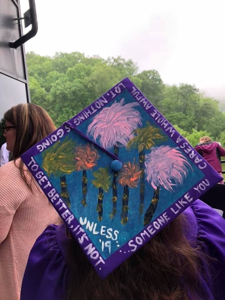 a purple graduation cap with palm trees on it