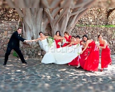 the bride and groom are posing with their bridal party in front of a tree