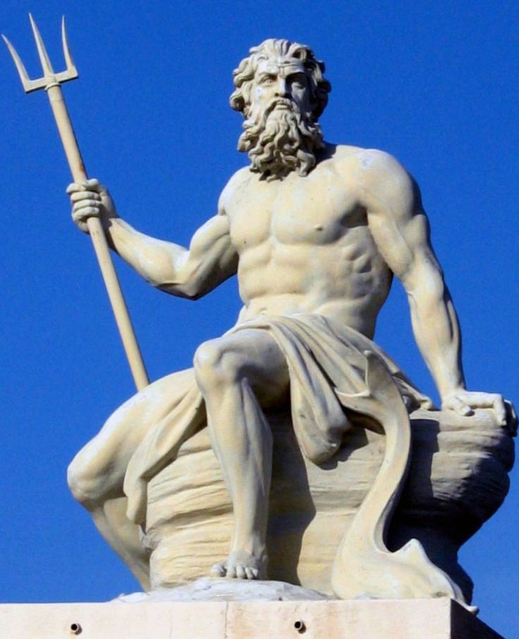 a statue of a man holding a spear and sitting on top of a stone pillar