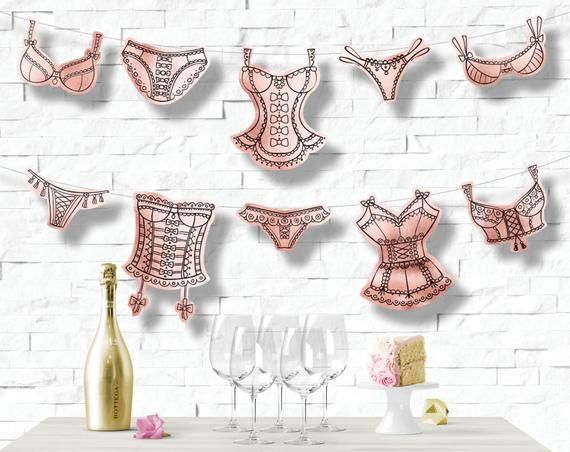 there are many bras and wine glasses on the table next to each other in front of a brick wall