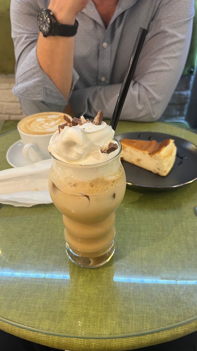 a person sitting at a table with food and drinks