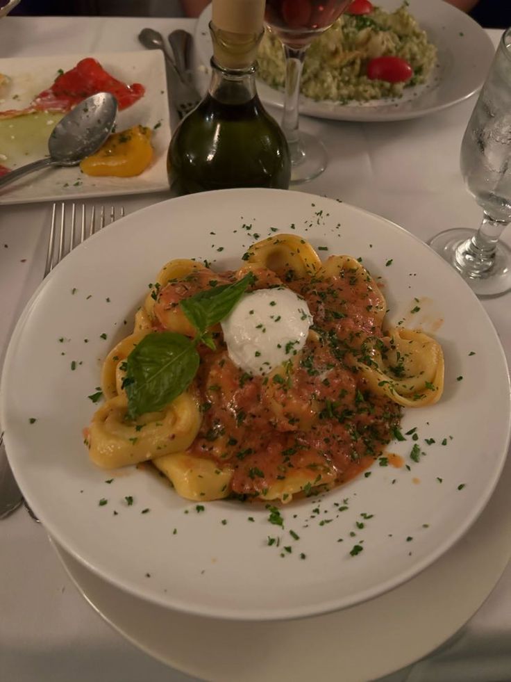 a white plate topped with pasta and sauce