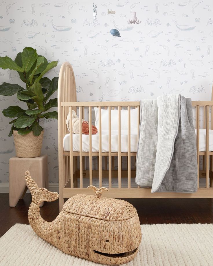 a baby's room with a crib, bed and potted plant on the floor