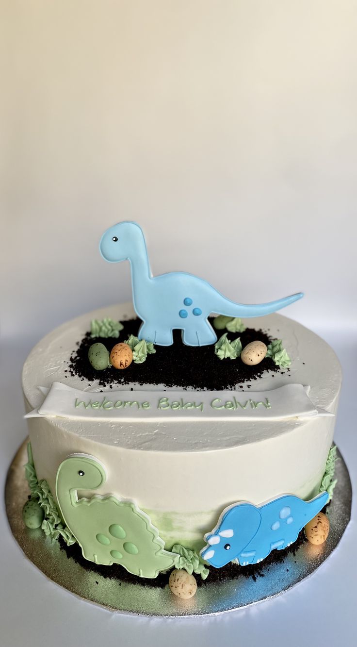 there is a dinosaur cake on the table