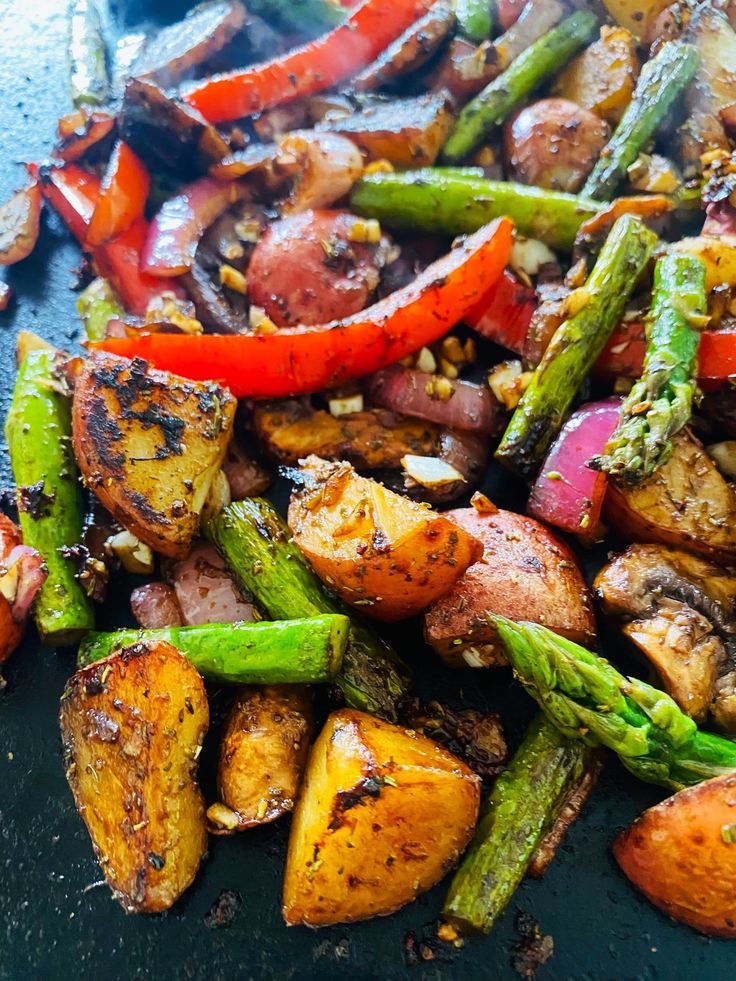 a close up of food on a plate with asparagus and potatoes in it