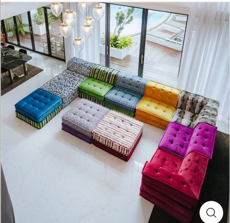 a living room filled with lots of colorful couches