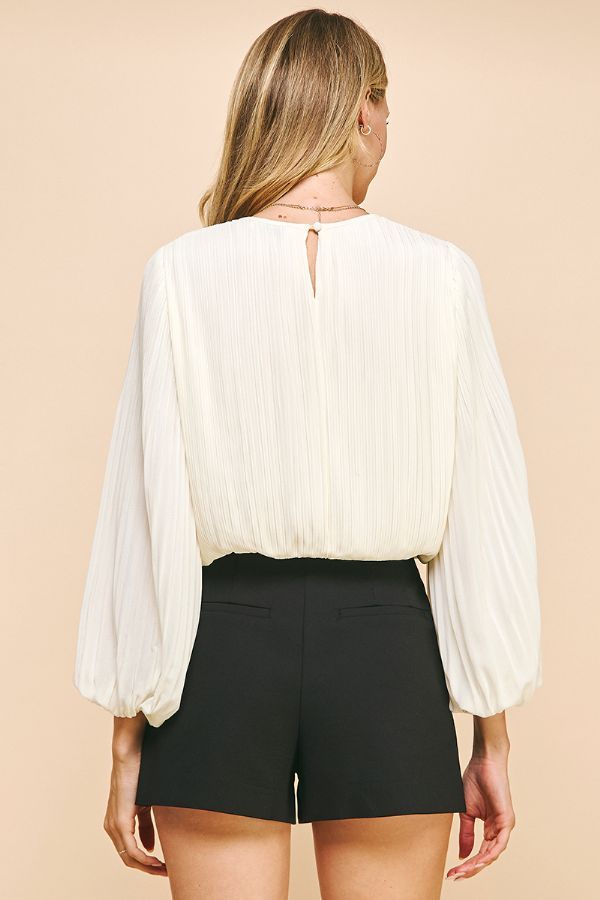 The Deserae Pleated Blouse is perfect for the office, date night or even a holiday gathering. Features an elegant bishop sleeve and gathered waist so it's easy to style and wear. Classy while being sophisticated - our favorite combination! Pleated Fabric Bishop Sleeves Gathered waistline (falls at waist) Round Neck Keyhole button back 100% Polyester Chic Blouse With Bishop Sleeves, Formal Top With Lantern Gathered Sleeves, Chic Padded Blouse With Bishop Sleeves, Chic Blouse With Pleated Lantern Sleeves, Chic Lantern Sleeve Blouse With Pleated Details, Chic Blouse With Bishop Blouson Sleeves, Chic Bishop Sleeve Blouse With Padding, Chic Long Sleeve Puff Sleeve Top For Party, Chic Office Blouse With Lantern Sleeves