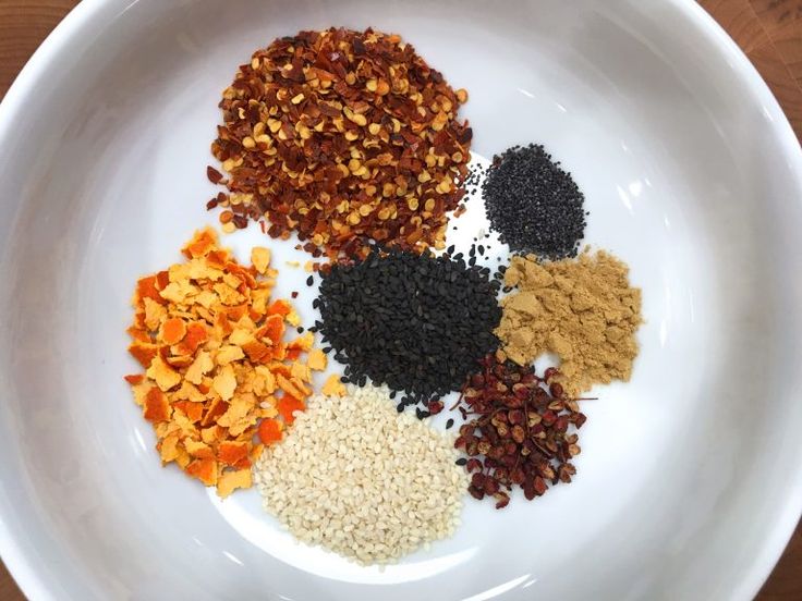 a white bowl filled with different types of spices