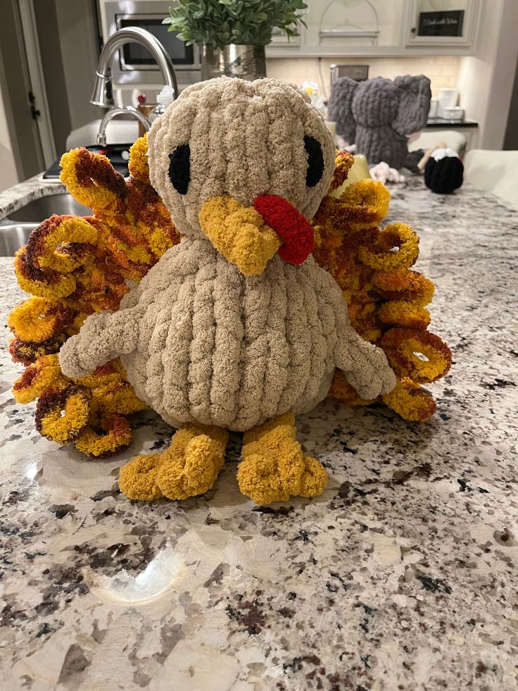 a stuffed bird sitting on top of a kitchen counter