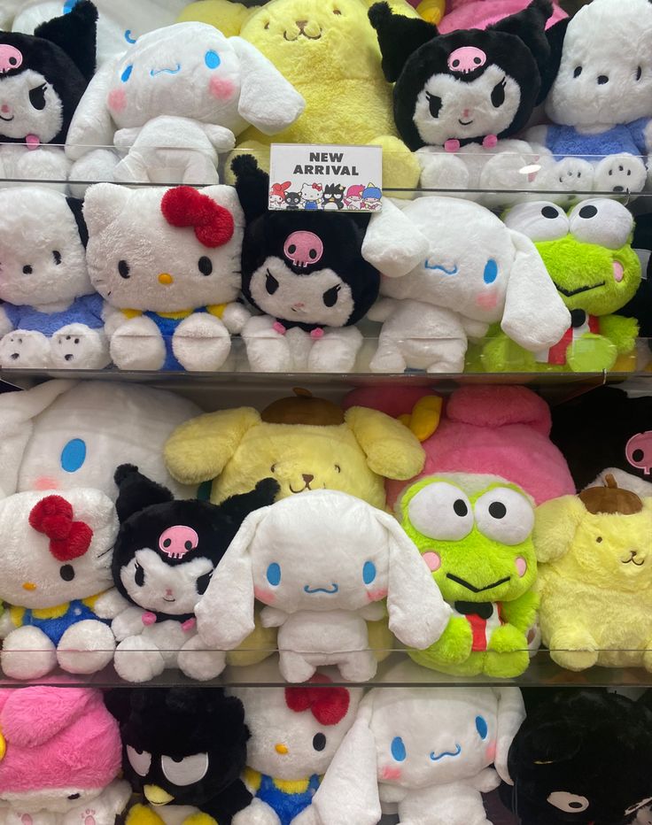 many different stuffed animals are on display in a toy store with price tags attached to them