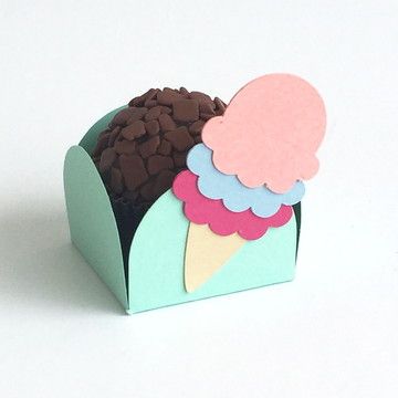 an ice cream cone with chocolate chips in it on a white surface, cut out from paper