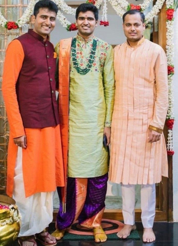 three men standing next to each other in front of a doorway