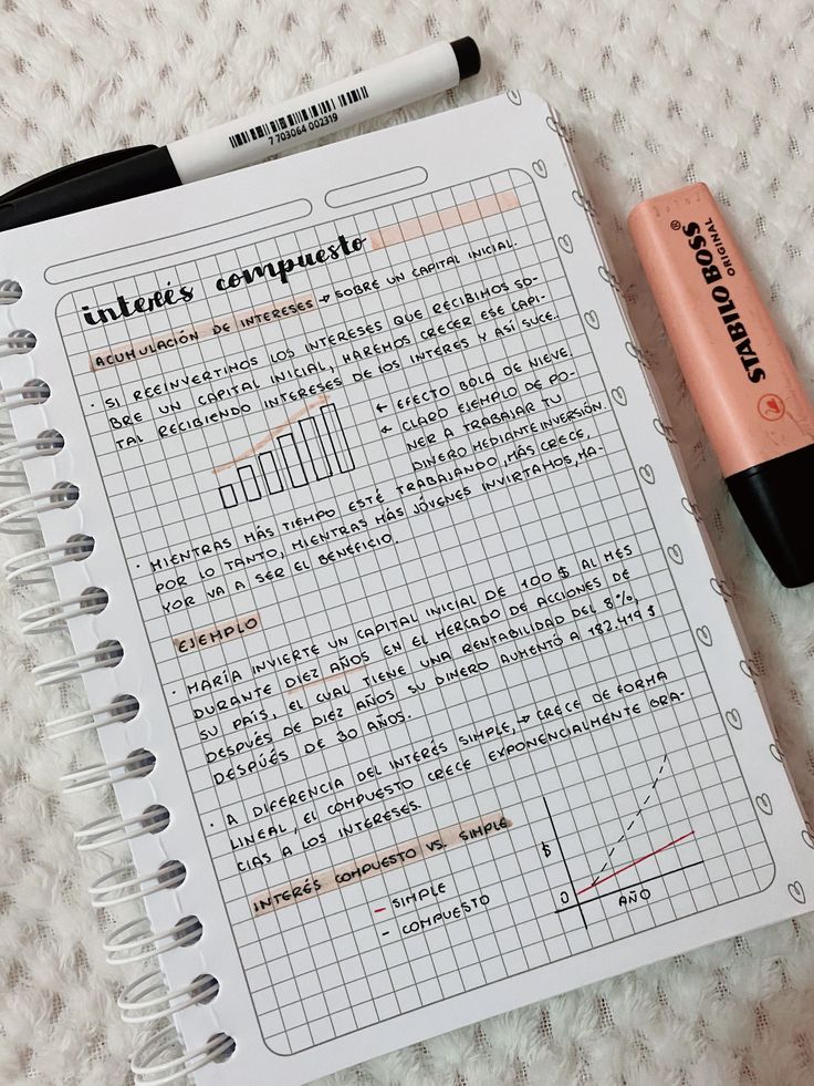 an open notebook with writing on it next to a pen and eraser sitting on a white surface