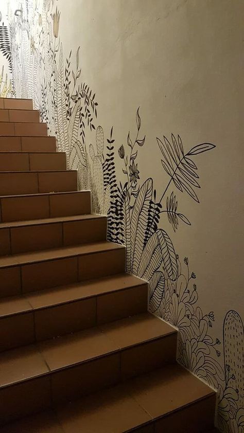 the stairs are painted with black and white flowers on them, along with an artistic wallpaper