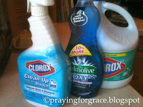 three bottles of cleaning products sitting on top of a counter