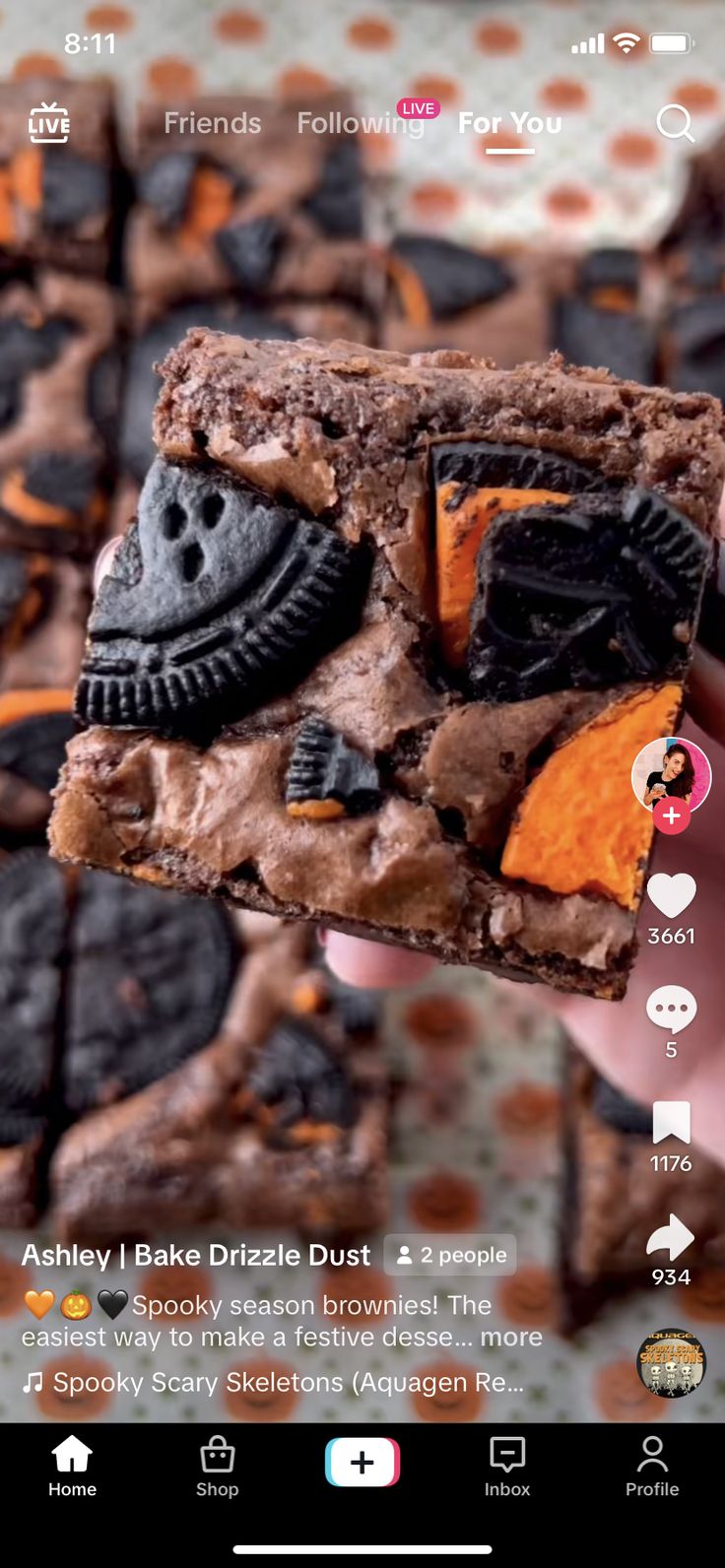 someone holding up a piece of cake with chocolate and oreo cookies on it's side