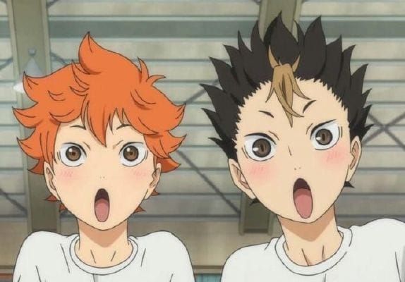 two young boys with their mouths open in front of the camera