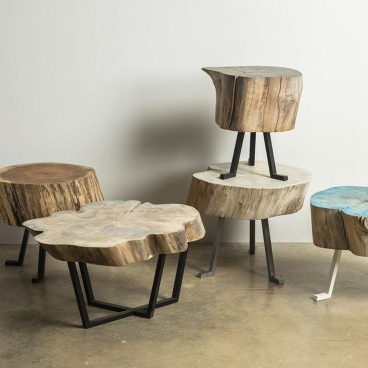 three tables made out of wood and metal stand next to each other on the floor