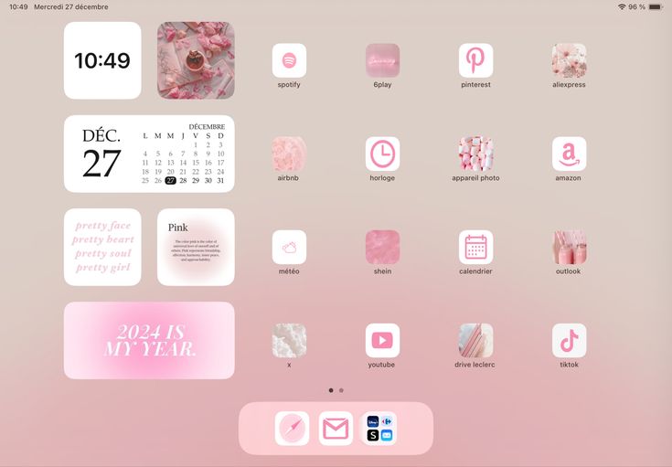 a pink and white desktop with various stickers on the screen, including calendars