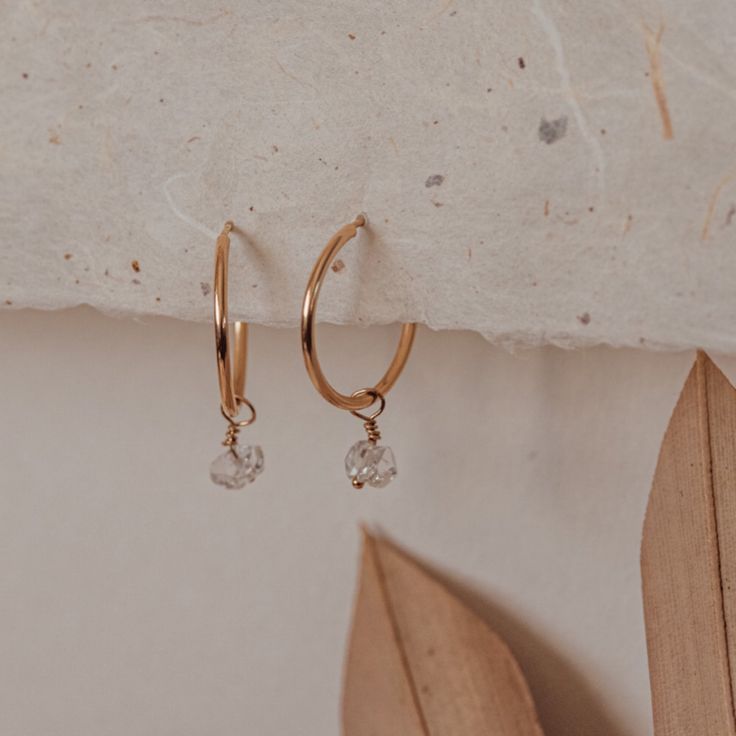 Our Herkimer diamond hoop earrings are the perfect combo of dainty and sparkly. Classic and minimal endless hoops are adorned with a tiny Herkimer diamond drop making them perfect for everyday wear. Herkimer diamonds are beautiful double-terminated quartz crystals found in Herkimer, New York. The quartz crystals you receive will vary in size (5-7mm) and shape because they are naturally formed so no two are alike! *Your Herkimer diamond may have inclusions and indentations with black spots inside Bangles Bracelets, Diamond Hoop Earrings, Bracelets And Necklaces, Quartz Crystals, Diamond Drops, Columbus Ohio, Herkimer Diamond, Black Spot, Silver Pieces