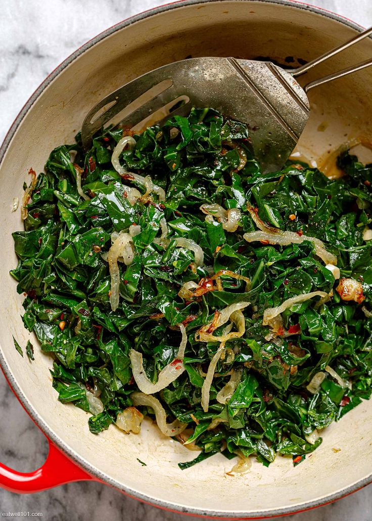 spinach and onions are being cooked in a pan