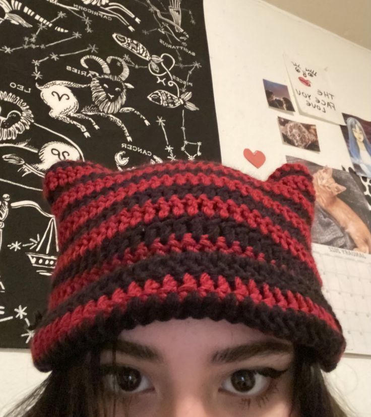 a close up of a person wearing a knitted hat with cat ears on it