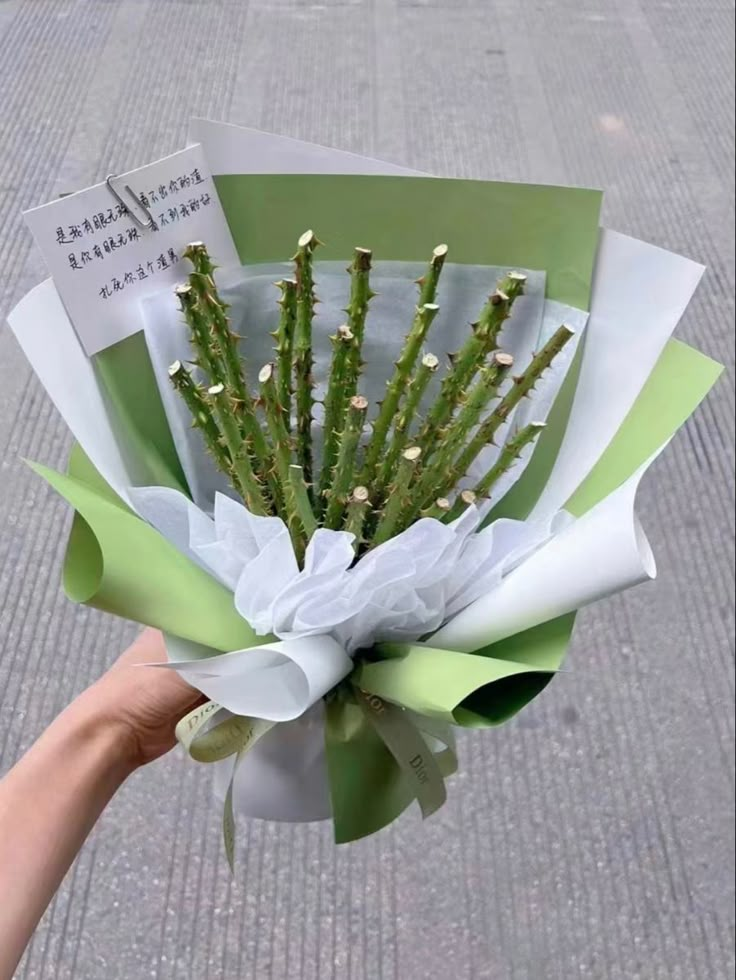 a person holding a bouquet of flowers in their hand