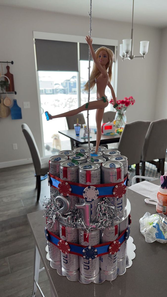 a cake made to look like a woman on top of cans